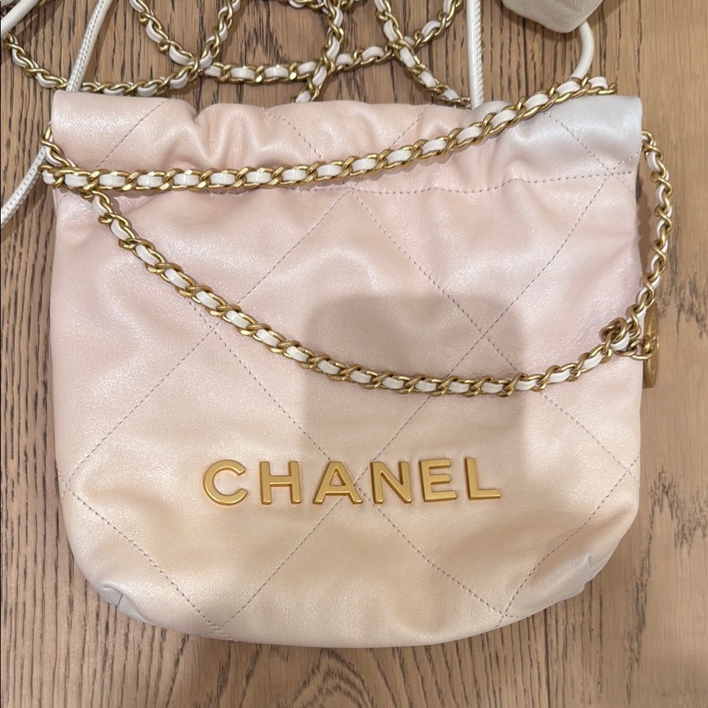 CHANEL 
Pearly Shaded Calfskin Quilted Mini Chanel 22 Ecru Golden